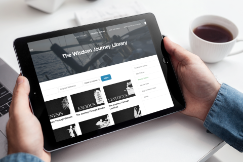 mockup of a man holding an ipad while drinking coffee 2164 el1